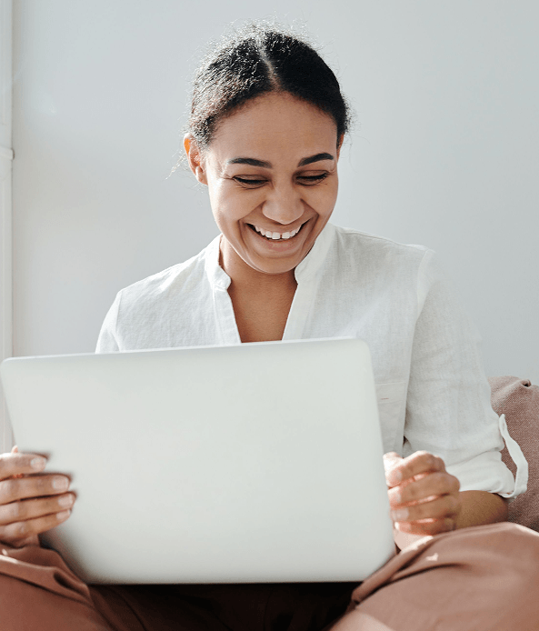 Person smiling during a virtual consultation on a laptop