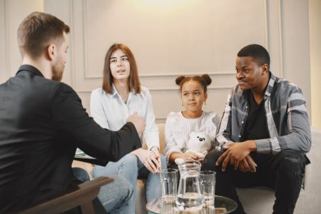 family-counseling-session-home-with-therapist-pshycologist-showing-pictures-emotions-girl-african-american-father-european-mother family-counseling-session-home-with-therapist-pshycologist-showing-pictures-emotions-girl-african-american-father-european-mother